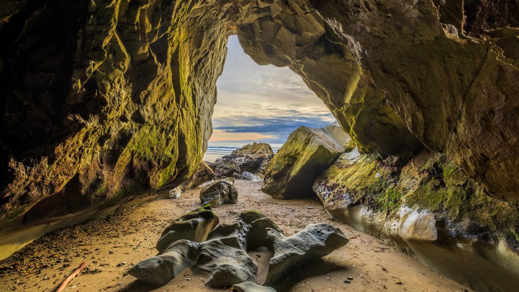 Sea cave at Pismo Beach with a rocky foreground at sunset, California, USA Sea cave at Pismo Beach with a rocky foreground at sunset, California, USA