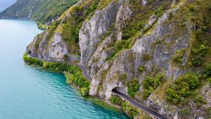 Aerial view of a scenic road with natural arch tunnel, Lake Iseo, Lombardy, Italy fe8d73626c5d4a725cbbaef5d7ff241b