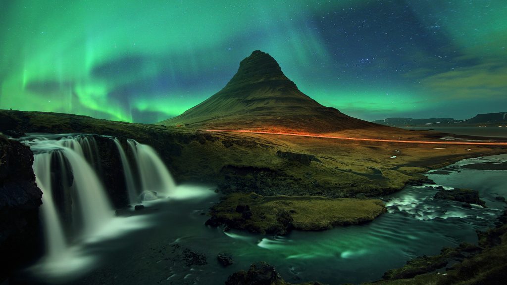 Northern lights (Aurora Borealis) over Kirkjufell mountain and Kirkjufellfoss waterfall, Iceland